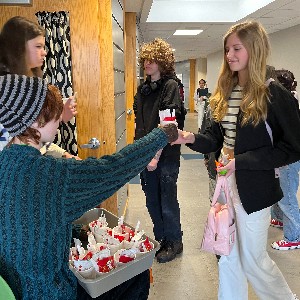 Handing out cups of cocoa to students with ducks.