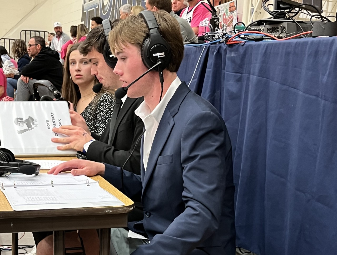 Broadcasting student provides live commentary at 1/31 Pinkout basketball game.