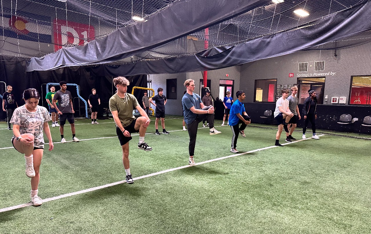Students and teachers from Liberty's sports training classes stretch their legs at the D1 training facility in Colorado Springs.