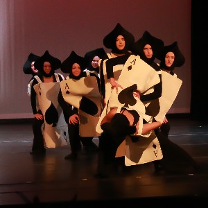 Dancers dressed as ace playing cards perform on Liberty's stage in the auditorium.