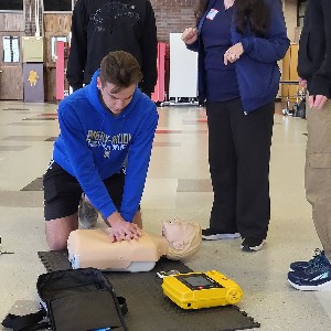 A Liberty student practices hands-only CPR on a mannikin during a training course at Liberty High School. 