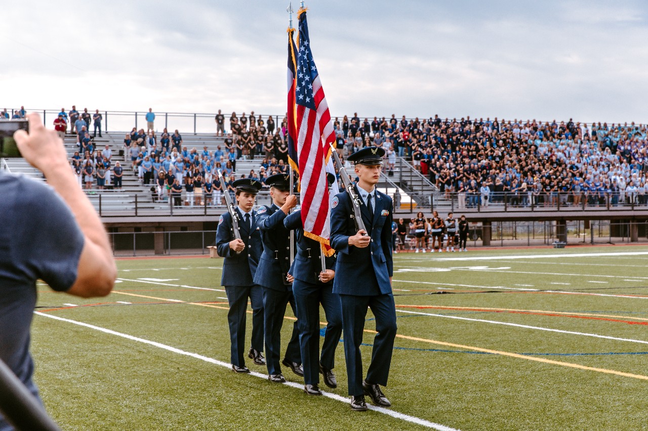 AFJROTC students presenting the USA and CO flags