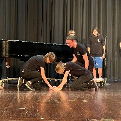 The crew retapes the positioning of the piano