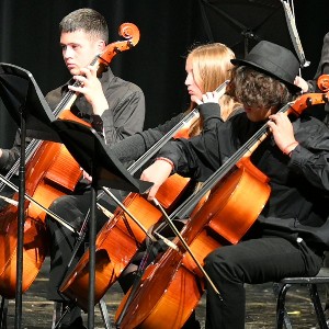 Three students playing cello