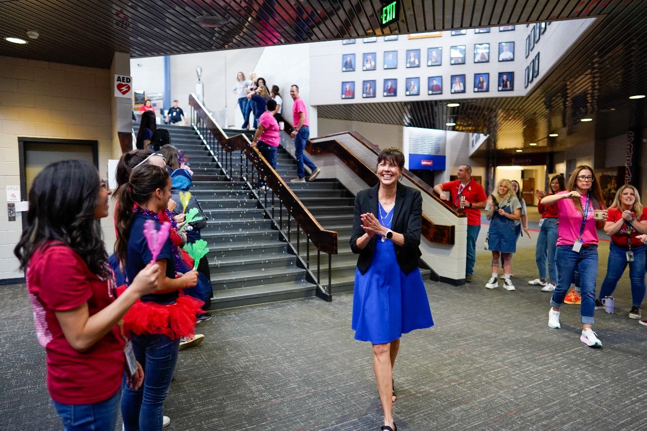 Superintendent Haberer in the Liberty High School lobby with students.