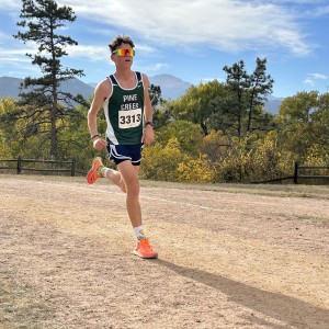 Boy running with orange sneakers and orange sunglasses