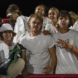 Student section smiles for the camera holding the Pine Creek goose