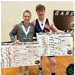 Two wrestlers pose holding brackets after Rocky Welton Invitational