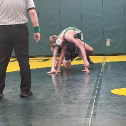 Two wrestlers on mat in the midst of competition