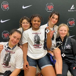 Small group shot of female wrestlers with medals