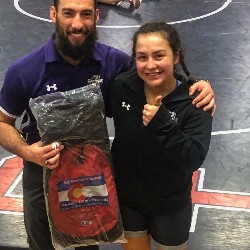 Female wrestler poses after winning Wrestler of the Week award