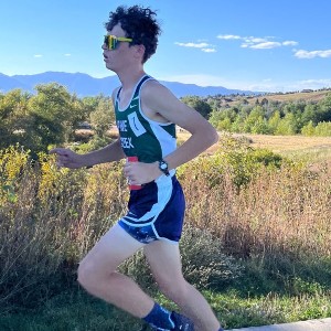 Boy running with mountains in background