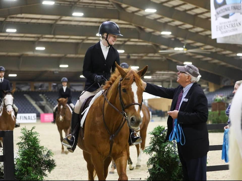 Student on horseback talking to the judge