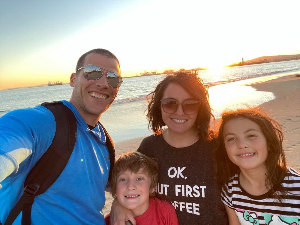 Principal Shelah Hansen and family pose on a beach.