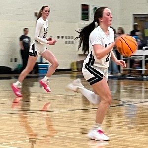 Girls point guard brings the ball up the court