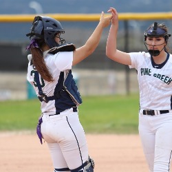 Two PCHS softball players give each other a "high-five" during a game.