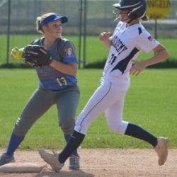A PCHS softball payer running to a base.