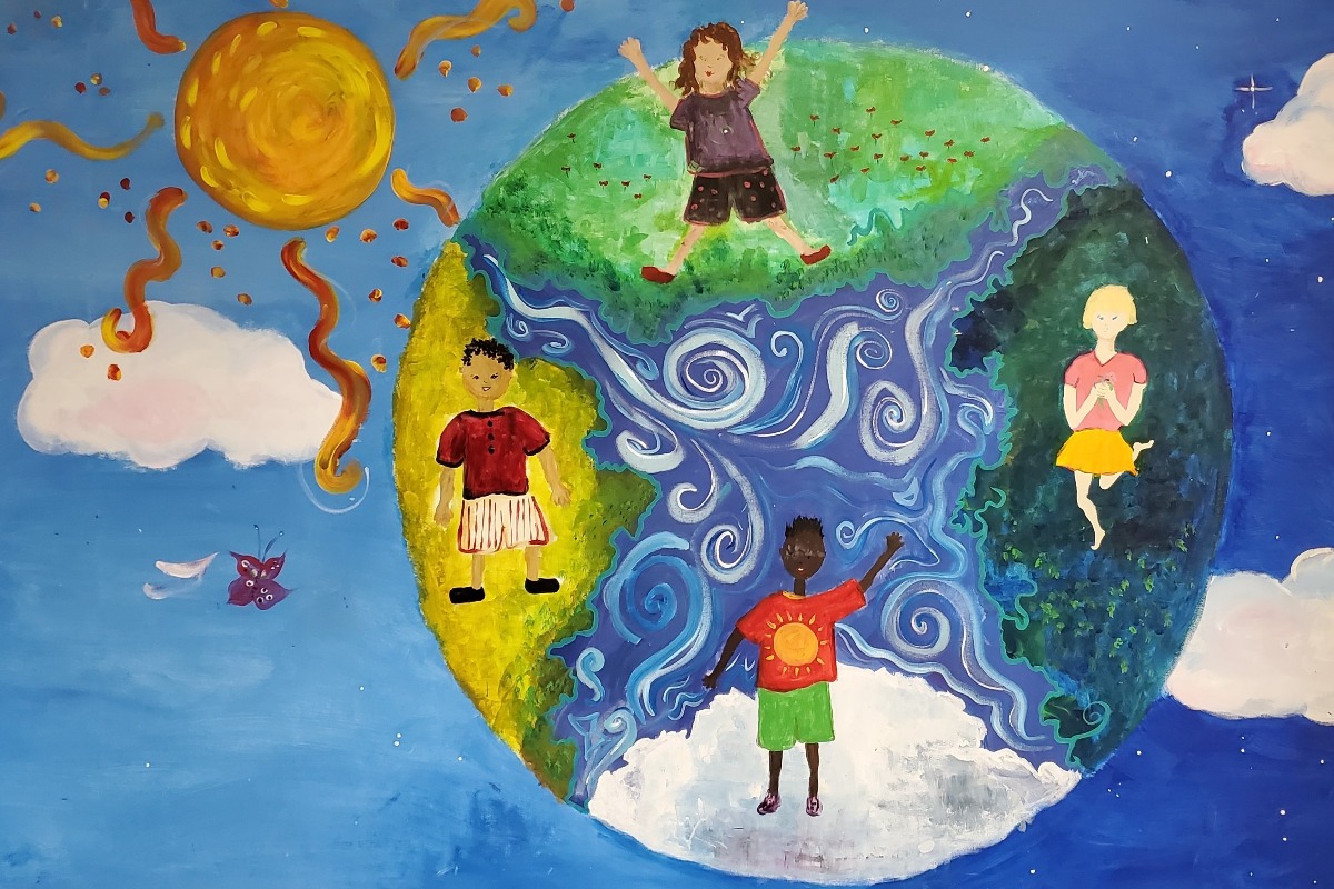 A student's artwork that shows the globe with a variety of students