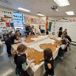 Students painting a canvas