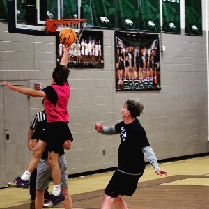 Student completing a jump shot