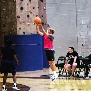 Student shooting basketball