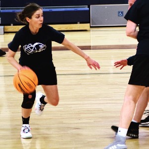 Woman dribbling basketball