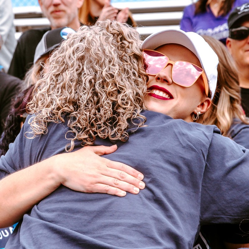 Two teachers hugging at the Back to School Rally.