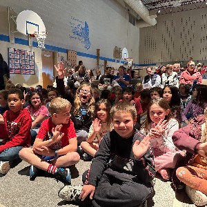 EES students sit on the gym floor waiting for the Veterans Day assembly to begin.