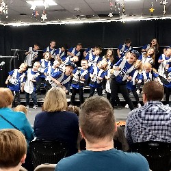 Students singing and dancing on stage.