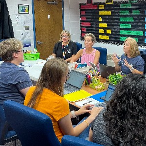 Teachers gather in a conference room