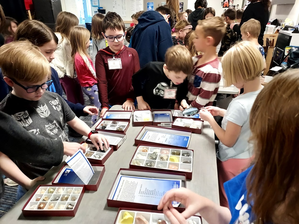 Students looking at rock collections.