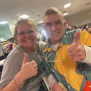 Teacher and student showing thumbs-up