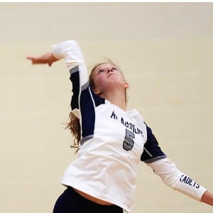 An AAHS Volleyball player serves the ball during a game.