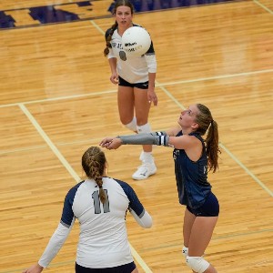 An AAHS volleyball player sets up the ball for another player to hit.